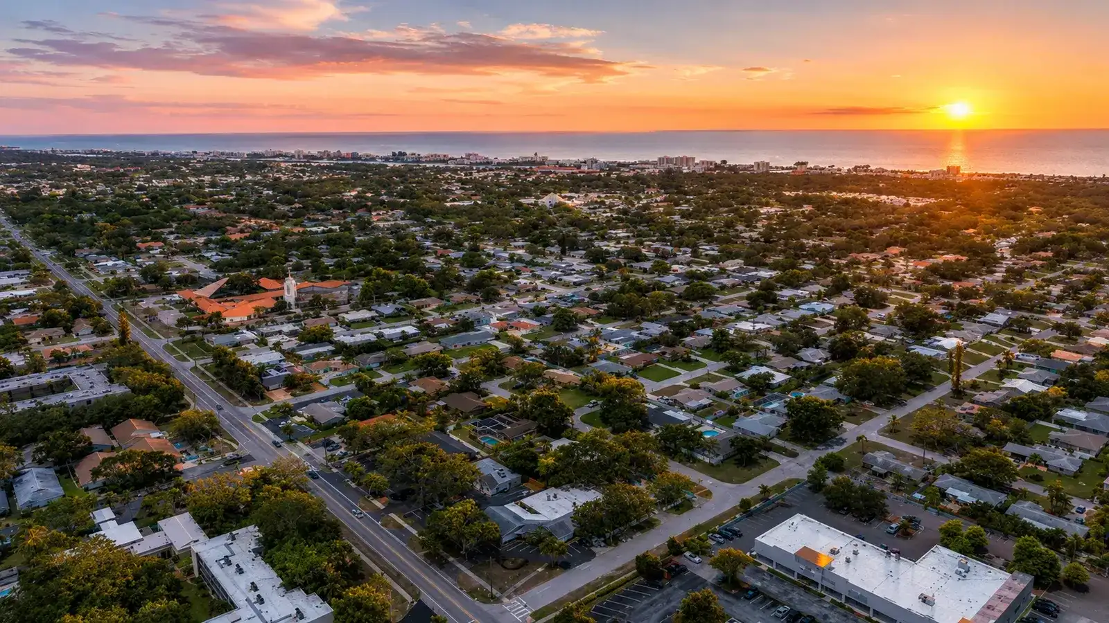 Aerial sunset over a central Pinellas neighborhood of single-family homes