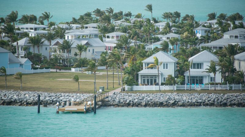 Pastel waterfront cottages and palm trees on Sunset Key across turquoise water near Key West
