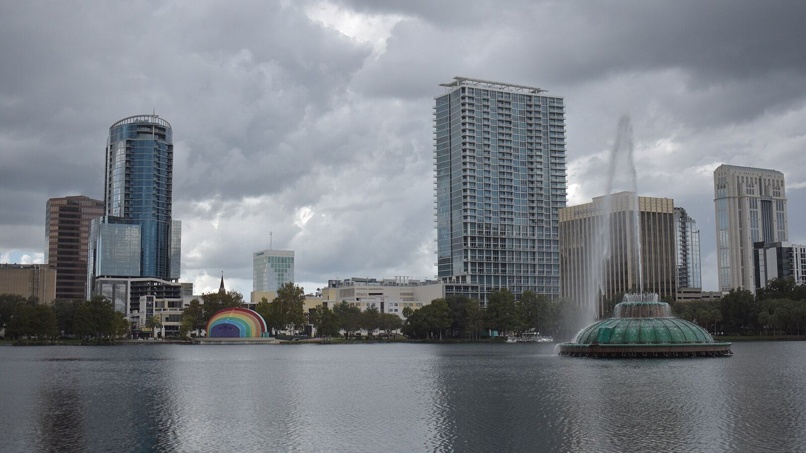 Downtown Orlando skyline and Lake Eola fountain under cloudy skies